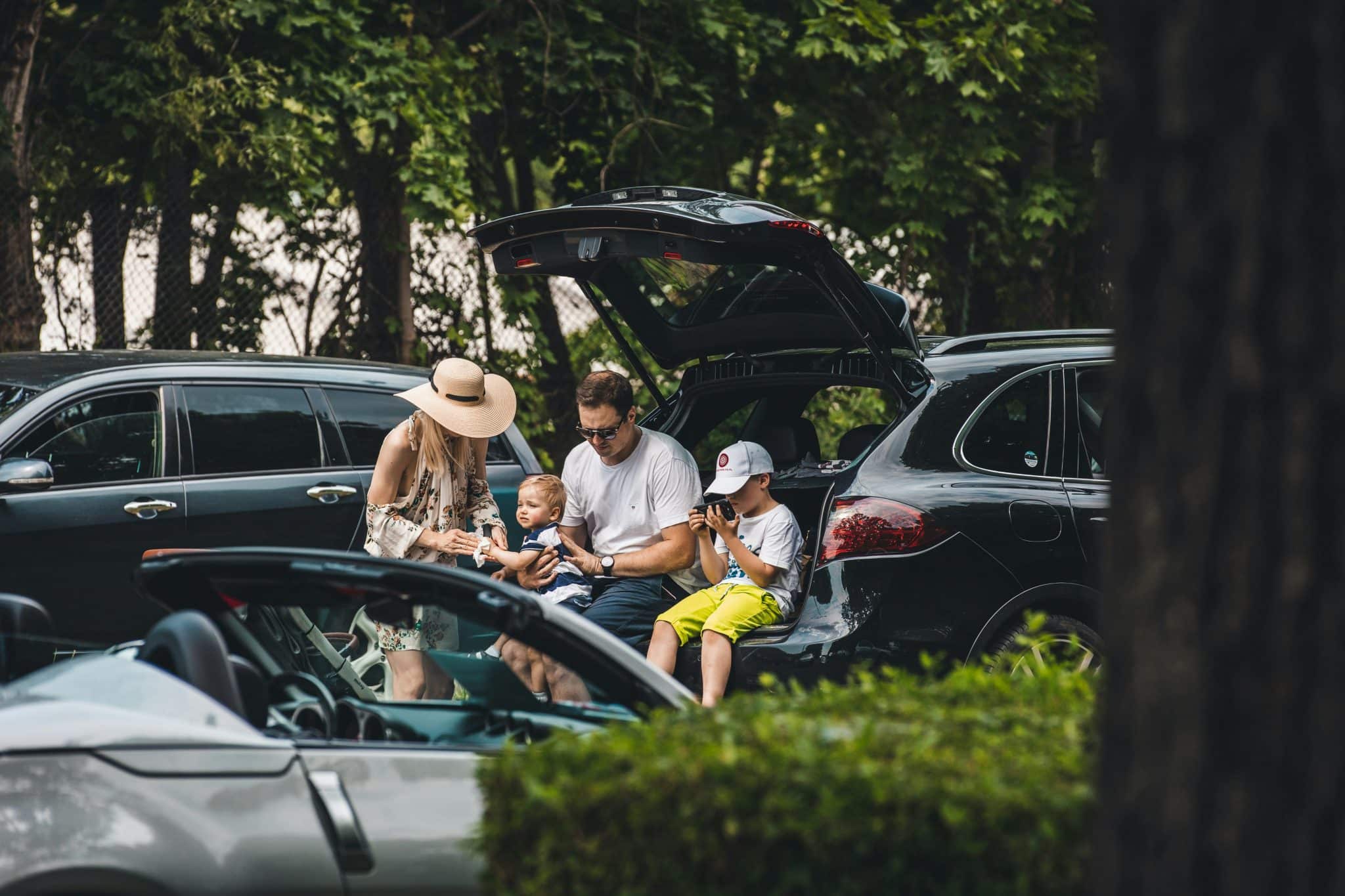 Family sits in the trunk of the car.